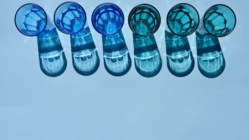 a row of blue toothbrushes sitting next to each other