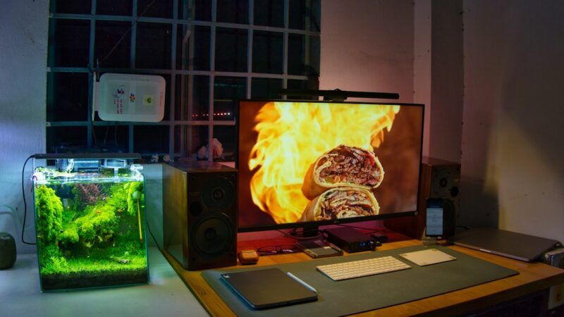 a desk with a monitor, keyboard and mouse on it