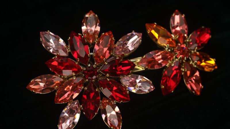 Two floral brooches with red and pink gemstones